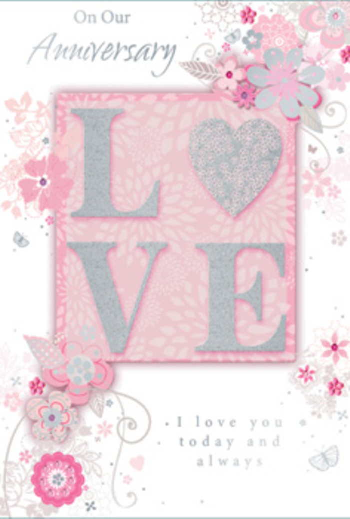 The image showcases a beautifully romantic anniversary card whose design carries the same care and finesse you might expect from an experienced Leatherhead florist. Dominating the centre is the word LOVE, rendered in bold, raised lettering that stands slightly above the card's surface. Each letter is dusted with a gauzy layer of glitter, giving off a soft, pearly sparkle that becomes more pronounced when the light shifts. This textured effect suggests a pleasing tactile quality, making the card feel special the moment it is held. Around this central motif, intricate clusters of stylised flowers and foliage weave and spiral in flowing patterns. The blooms are sketched with delicate lines and shaded in gentle hues of blush pink, cream and gentle grey, recalling blossoms arranged for an anniversary dinner table in a Leatherhead home. Slender stems curl gracefully, while fine leaves and small flourishes create a sense of motion and lightness, as if a soft breeze were playing across the paper. Silver accents, applied sparingly to selected petals and scrolls, lend a discreet shimmer that enhances the design's sophistication. The background is a soft, rosy-pink field, subtly textured in appearance yet visually calm, allowing the raised letters and florals to take centre stage. Nestled within this artwork, an anniversary sentiment in elegant script honours lasting love, shared memories and quiet devotion, the lines arranged with an almost calligraphic grace. The overall effect is that of a paper bouquet: tender, artful and deeply personal, perfect for marking another year of love in Leatherhead with warmth and sincerity.